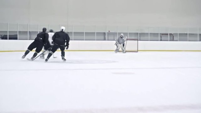 Tracking of ice hockey player in white uniform dribbling puck past defensemen in black gear and then scoring goal