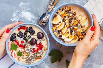 Healthy vegan breakfast: chocolate and berry smoothies bowls.