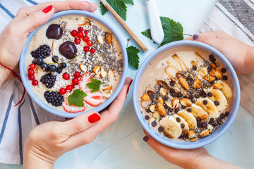 Healthy vegan breakfast: chocolate and berry smoothies bowls.