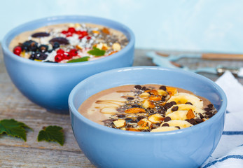 Healthy vegan breakfast: chocolate and berry smoothies bowls.