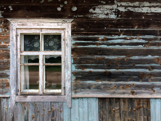 Obraz na płótnie Canvas The window of the old house. Blue cracked paint