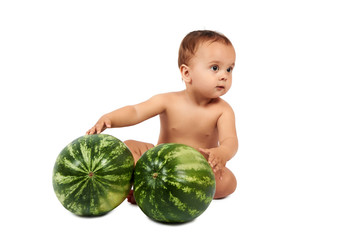 Fototapeta premium Cute little infant baby girl eating watermelon slice on white background