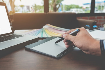 Graphic design and color swatches and pens on a desk. Architectural drawing with work tools and accessories. .
