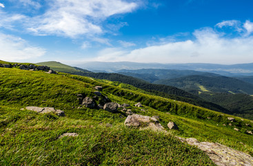 Fototapeta premium blue cloudy sky over the mountains with rocky hillside