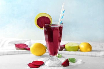 Composition with healthy beet smoothie in cocktail glass with straw and some ingredients