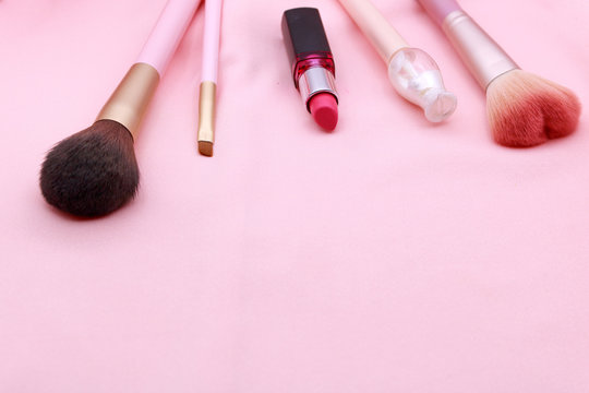 Make up products on pink background.
