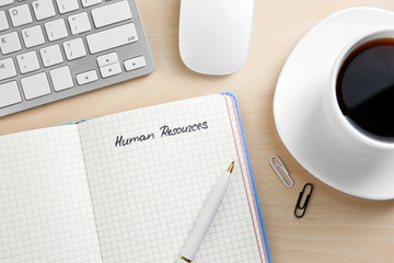 Copybook,keyboard and cup of coffee on wooden background. Management concept © Africa Studio