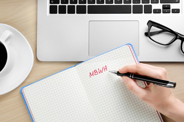 Female hand writing text in notebook. Management concept © Africa Studio