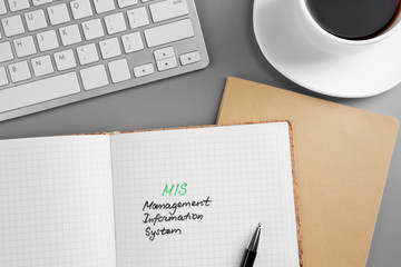 Copybook and keyboard on grey background. Management concept © Africa Studio