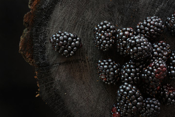 Blackberries on black wooden background