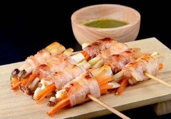 Bacon roll with mushroom and carrot grilled.