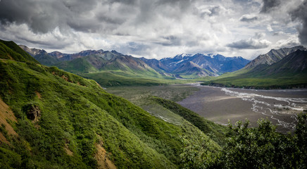Panorama mountains and braided river in valley on an overcast day in Denali National Park, Alaska, United States