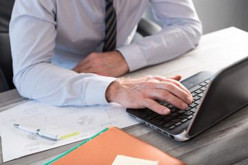 Male hands using a laptop