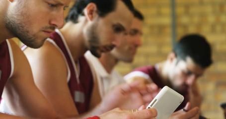 Coach and basketball players using digital tablet - Powered by Adobe