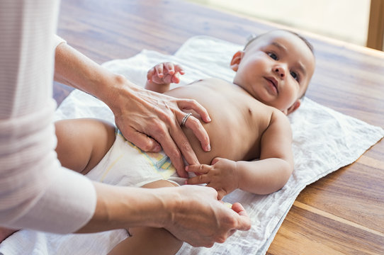 Mother Changing Baby Diaper