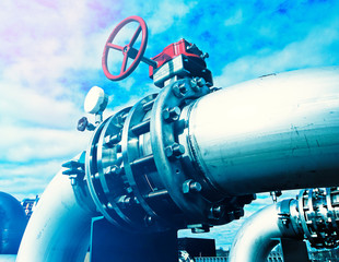 Industrial zone, Steel pipelines and valves against blue sky