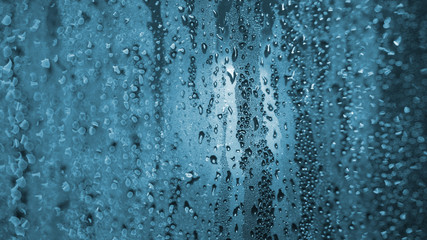 The drops on glass bokeh background.