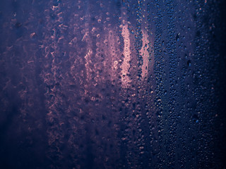 The drops on glass bokeh background.