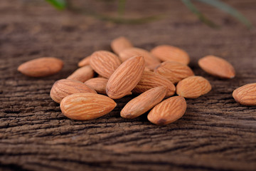 dried uncooked almond on wooden background