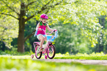 Child riding bike. Kid on bicycle.