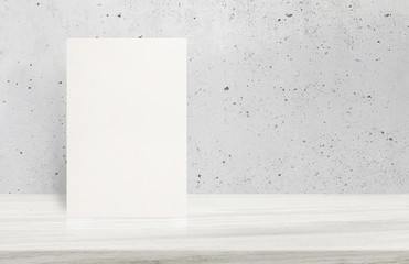 Blank White paper poster on stone table top at grey old concrete wall,Template mock up for adding...