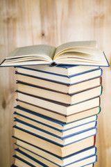 Stack of books on a wooden background.
