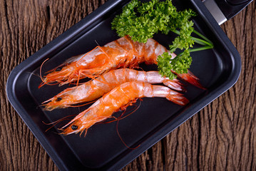 sweet Shrimps stretch boiled in pan on wooden background