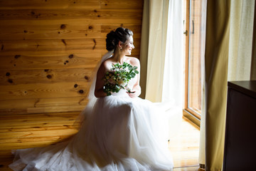 Best wedding morning. Wedding concept - The bride waits for the groom near the window at home