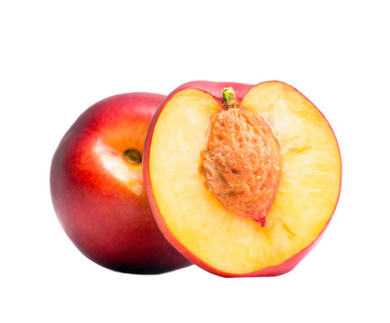 Nectarine whole and half of nectarine with a stone. Isolated nectarines on a white background. Summer juicy fruit. Healthy food. Bright juicy colors.
