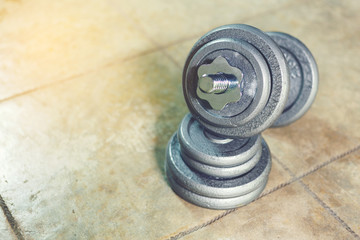 Obraz premium Iron Dumbbell on the floor with adjust iron weight plate.