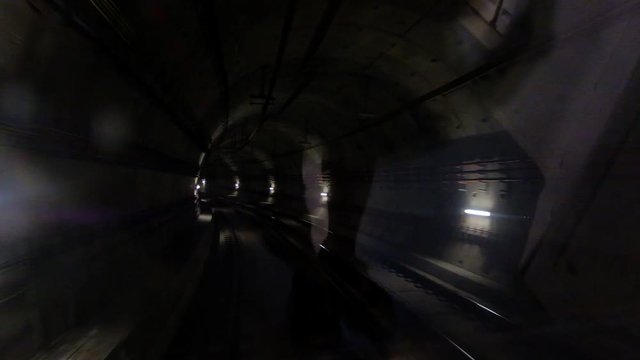 Traffic on a dark subway tunnel with a stop in front of the station