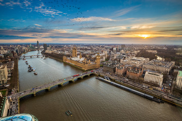 Fototapeta na wymiar London, England - Aerial view of central London, with Big Ben, Houses of Parliament, Westminster Bridge, Lambeth Bridge at sunset with flying birds