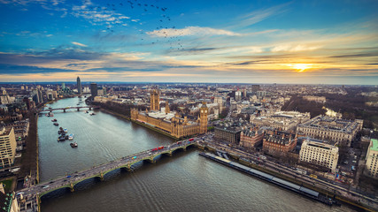 Fototapeta London, England - Aerial view of central London, with Big Ben, Houses of Parliament, Westminster Bridge, Lambeth Bridge at sunset with flying birds obraz