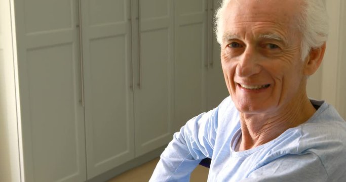 Portrait of smiling senior man sitting on wheelchair