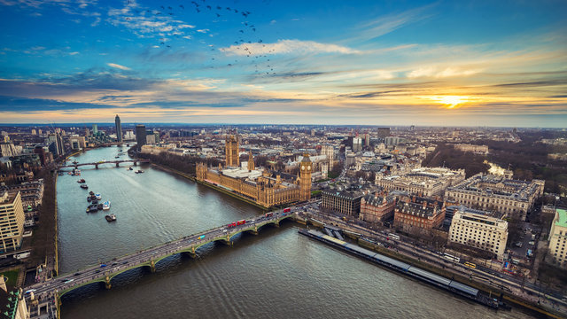 London, England - Aerial view of central London, with Big Ben, Houses of Parliament, Westminster Bridge, Lambeth Bridge at sunset with flying birds