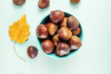 Chestnuts and autumn leaves, overhead photo with copyspace