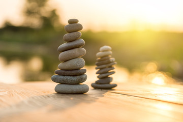 Obraz premium Zen Balancing Pebbles Next to a Misty Lake