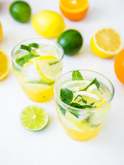 Fresh citrus lemonade with limes, mint leaves and lemons in glasses