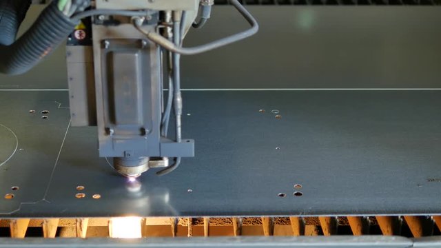 Laser cut machine while cutting the sheet metal with sparking light and high precision 