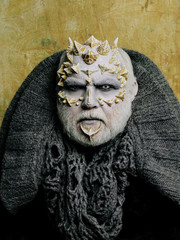 Monster face with white eyes, sharp thorns and warts