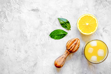 freshly squeezed orange juice on concrete background top view