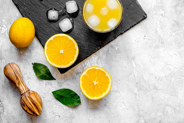 freshly squeezed orange juice on concrete background top view