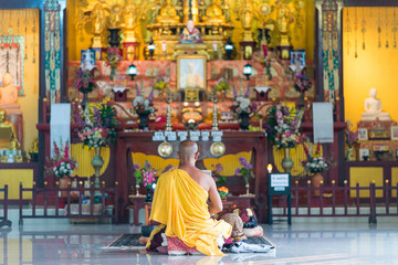 Japanese monk in meditative posture in the Temple of the Japanese Peace Pagoda in Unawatuna. The buddhist Stupa is a monument that inspired for peace