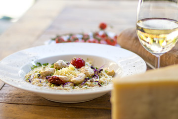 A plate of risotto with parmesan and chicken