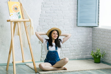 Portrait of gorgeous woman artist  painting at home