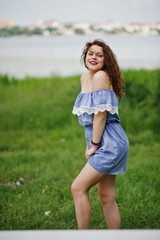 Portrait of a fantastic young girl having fun in the park next to the lake.