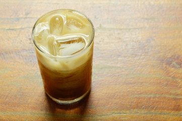 ice coffee topping milk floating in glass