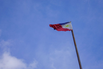 Flag of Philippines raised up in the sky - Powered by Adobe