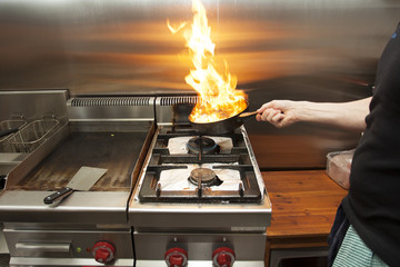 Chef cooking on a gas stove