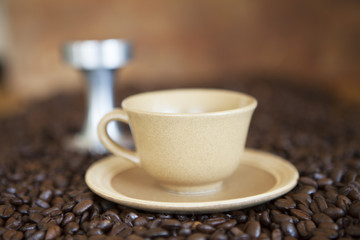 Coffee cup on coffee beans